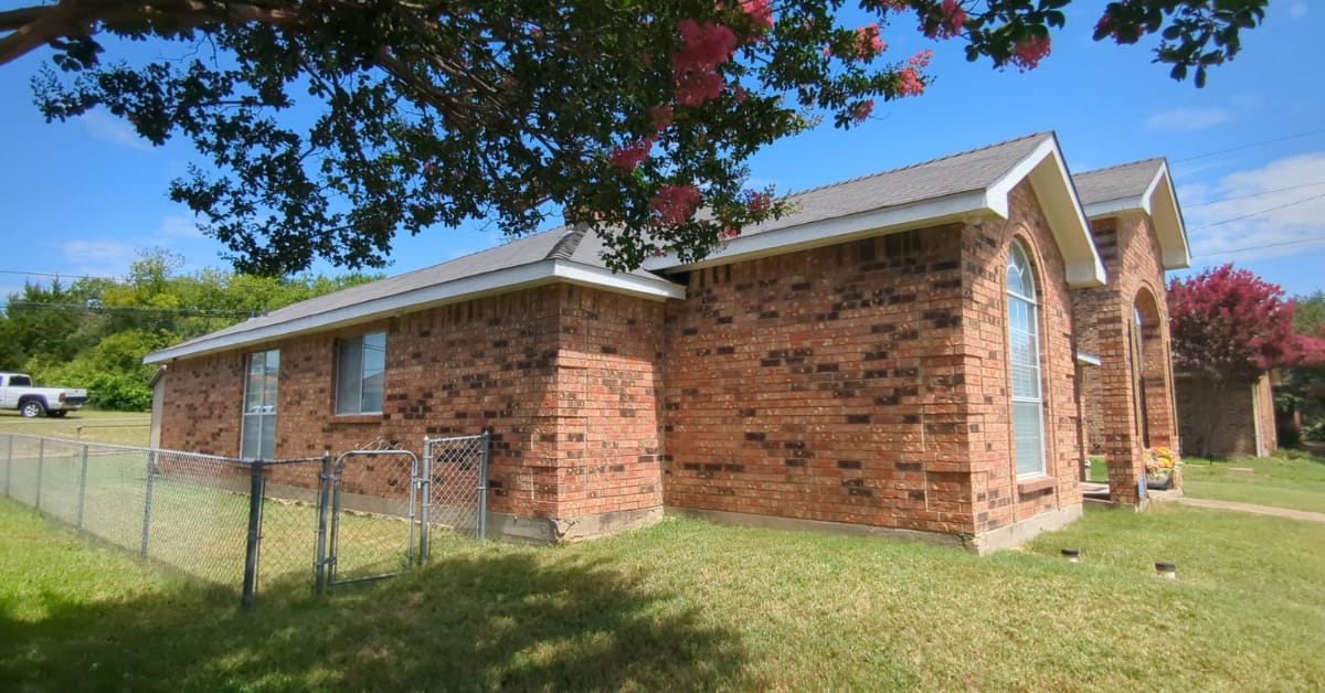 Residential roof replacement by DFW Roofers in Dallas, Texas, highlighting backyard