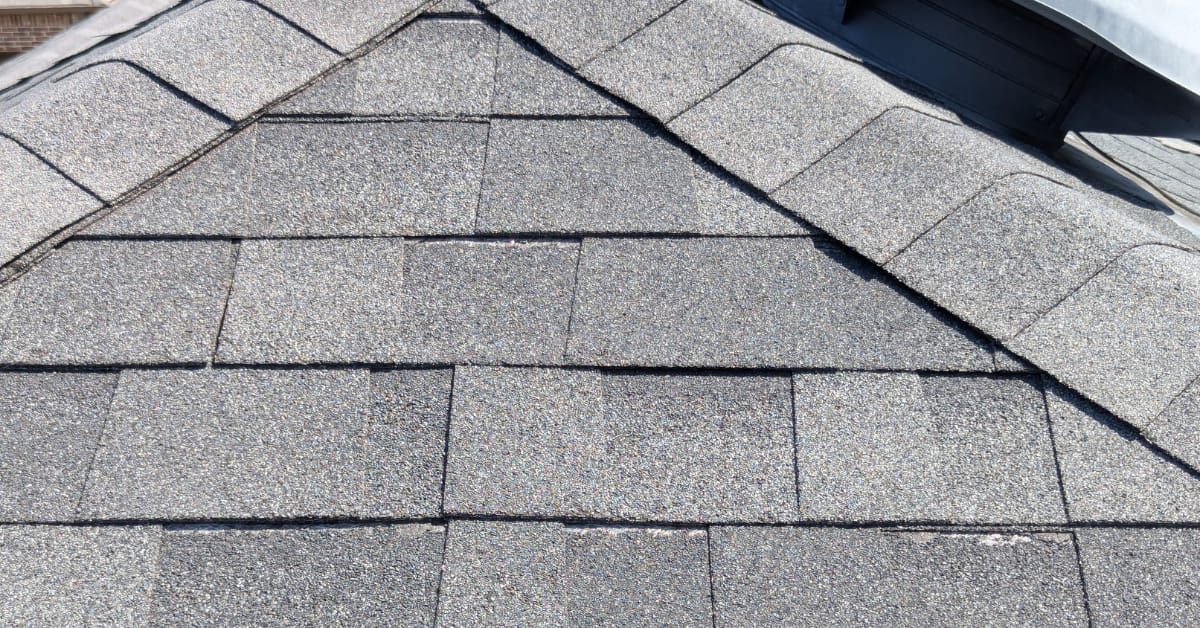 Residential roof replacement by DFW Roofers in Carrollton, Texas, highlighting roof damage